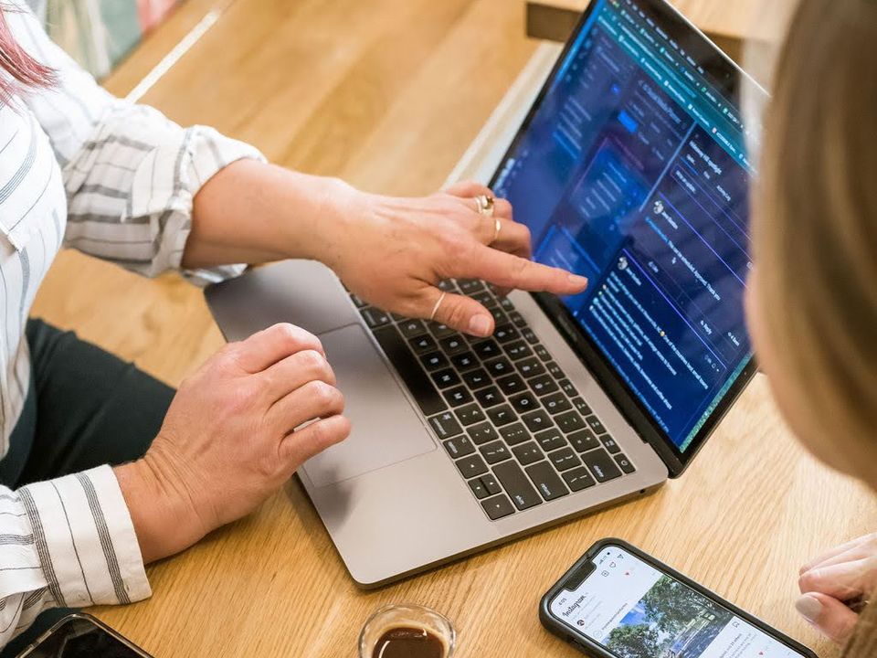 Reviewing campaign results together on a laptop at a table